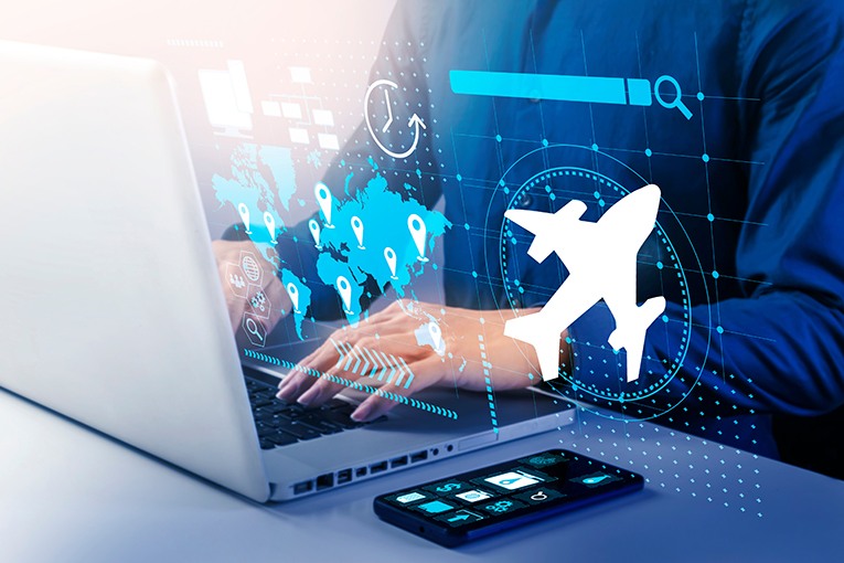 hands on a laptop with travel-related icons superimposed